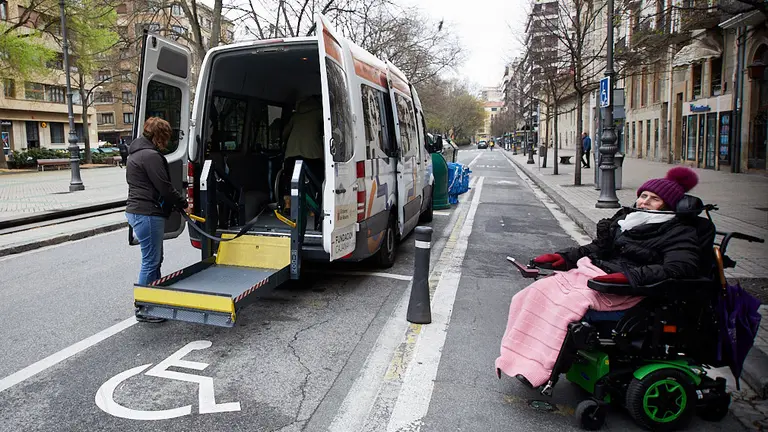 Varias personas con discapacidad y movilidad reducida descienden de un vehículo adaptado y se reúnen en el Paseo Sarasate dentro de un acto organizado por Cocemfe para que se respeten las plazas de aparcamiento reservadas. IÑIGO ALZUGARAY