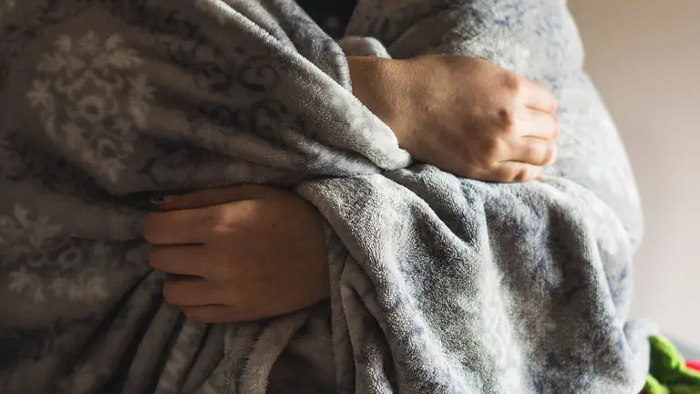 Una joven se arropa con una manta. ARCHIVO