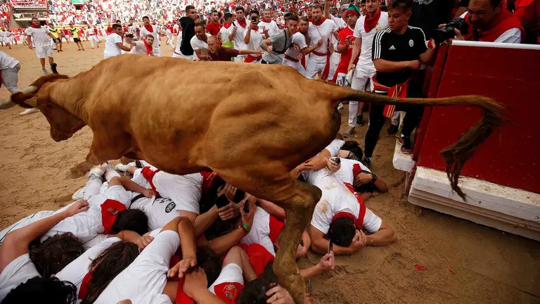 Revellers sprint near bulls and steers during the running of the bulls at the San Fermin festival in Pamplona, Spain, July 9, 2019.   *** Local Caption *** .