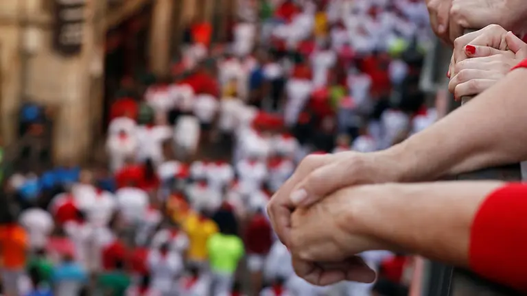 Revellers wait on a balcony before the running of the bulls at the San Fermin festival in Pamplona, Spain, July 12, 2019. REUTERS/Susana Vera
