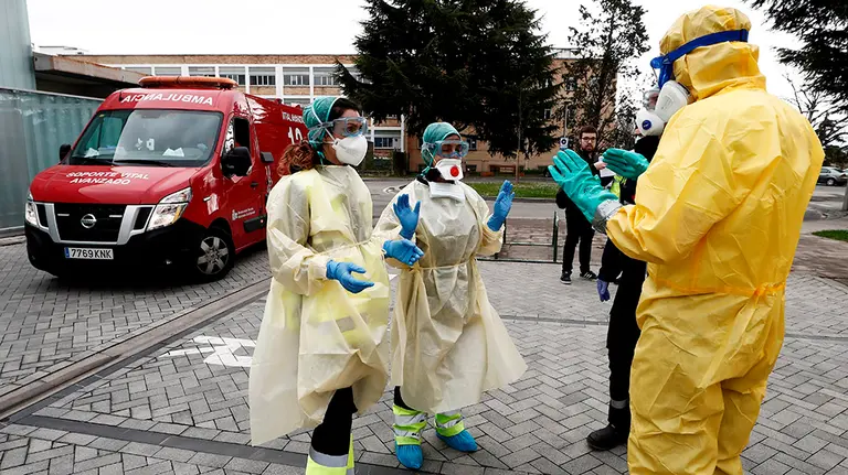 GRAFCAV3839. PAMPLONA, 25/03/2020.-  Dos enfermeras que acaban de trasladar en ambulancia a un enfermo que ha dado positivo en el test del COVID-19 solicitan ayuda de un efectivo de la DYA Navarra que en coordinación con el departamento de Salud ha implantado un túnel de desinfección en el Complejo Hospitalario de Navarra para desinfectar tanto ambulancias, como material médico intrahospitalario. El proceso de desinfección de las ambulancias se realiza con un tratamiento de ozono, agua y lejía, garantizando así que vuelva a salir limpia.   EFE/ Jesús Diges
