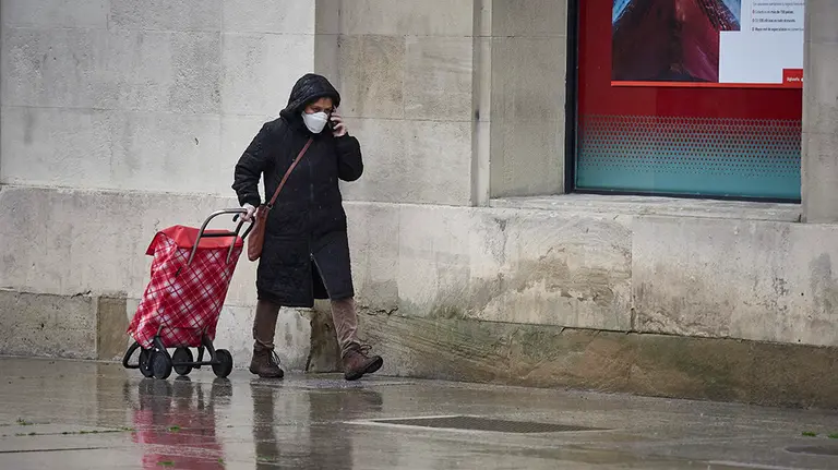 Una mujer con mascarilla camina bajo la lluvia con el carro de la compra durante el Martes Santo y la cuarta semana del estado de alarma decretado por el Gobierno por la crisis del coronavirus, en Pamplona/Navarra (España) a 7 de abril de 2020.

FRÍO;LLUVIA;MAL TIEMPO;COVID-19;CONFINAMIENTO;PANDEMIA;ENFERMEDAD;BAJAS TEMPERATURAS;PARAGUAS

7/4/2020