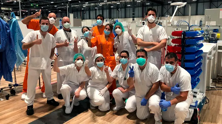 Fotografía facilitada por la doctora Aida Suárez, que muestra a un equipo de médicos, enfermeros, auxiliares y celadores, cuando se abrieron las UVIs  del hospital de Ifema. Aida Suárez, cardióloga en la Clínica de Navarra en Madrid, colabora como voluntaria en Ifema, una experiencia "enriquecedora", dicen, por la predisposición a "ayudarse unos a otros" durante la pandemia. EFE
