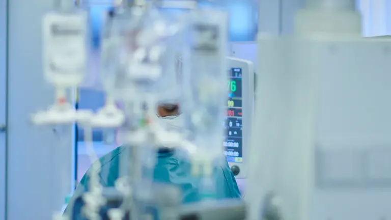 Una enfermera atiende a un paciente con coronavirus en la UCI de la CUN. PABLO LASAOSA