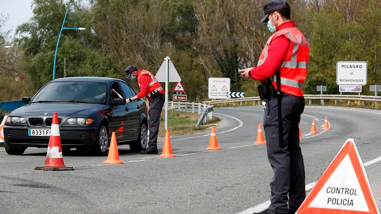 Efectivos de la Policía Foral controlan los accesos a la localidad navarra de Milagro que desde hoy y hasta el 11 de abril mantiene un confinamiento perimetral. El Ayuntamiento de Milagro, ha aprobado un paquete de medidas extraordinarias para contener la expansión del covid-19 en esta localidad ribera, en el municipio, de algo más de 3400 habitantes, la incidencia acumulada de los últimos 14 días es de 1873 casos por 100.000 habitantes, mientras que en los últimos 7 días la cifra se sitúa en 1610 casos.   EFE/ Jesús Diges