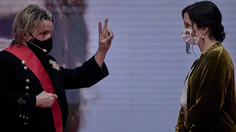 La presidenta de la Comunidad de Madrid, Isabel Díaz Ayuso (d), entrega la Gran Cruz de la Orden del Dos de Mayo al músico Nacho Cano, durante la ceremonia de imposición de Medallas de la Comunidad de Madrid y condecoraciones de la Orden del Dos de Mayo, con motivo del Día de la Comunidad de Madrid. J. Hellín. POOL / Europa Press 2/5/2021