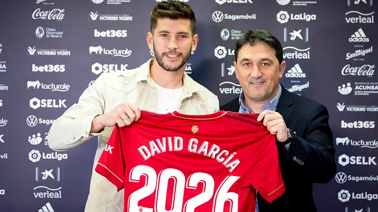 David Garcia y Braulio Vázquez sostienen la camiseta de la ampliación de contrato del defensa. CA Osasuna.