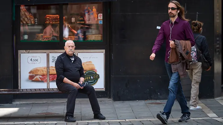 Un hombre sin mascarilla sentado en la plaza del Ayuntamiento de Pamplona una semana antes de la nueva bajada de restricciones por la pandemia del coronavirus en la Comunidad Foral de Navarra. MIGUEL OSÉS