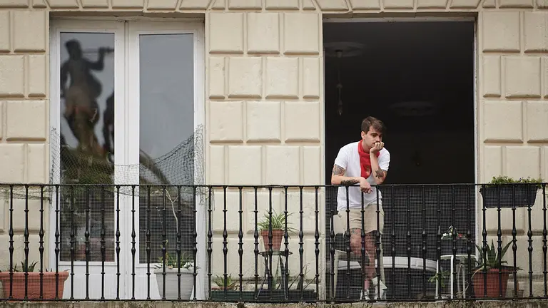 Varias personas en los balcones de la Plaza del Ayuntamiento en las no fiestas de San Fermín de 2021. PABLO LASAOSA