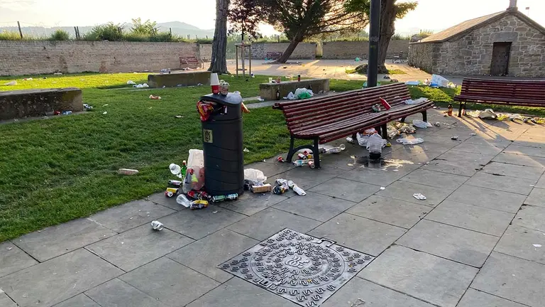 Aspecto que presentaba el Caballo Blanco, con basura por los bancos, césped o suelo. POLICÍA MUNICIPAL