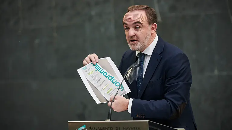 Javier Esparza, de Navarra Suma, enseña un cartel repartido por EH Bildu dirante su comparecencia ante la prensa tras la Mesa y Junta. PABLO LASAOSa