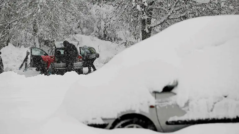RONCESVALLES (NAVARRA), 28/11/2021.- Un grupo de personas preparan sus esquis para realizar una peque&ntilde;a traves&iacute;a desde un parking de la Colegiata de Roncesvalles en una jornada donde tras la intensa nevada ca&iacute;da en las &uacute;ltimas horas ha dejado espesores de nieve de mas de 40 centimetros en Roncesvalles. EFE/Jes&uacute;s Diges
