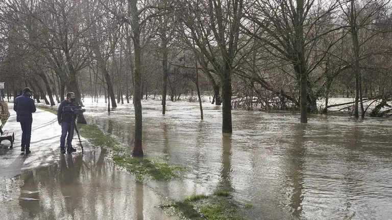 Varias personas en la zona donde el río Arga se ha desbordado, a su paso por Pamplona. EDUARDO SANZ (EUROPA PRESS)