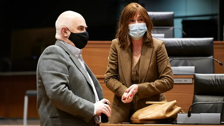 El consejero Aierdi habla con Uxue Barkos en el pleno del Parlamento. PABLO LASAOSA