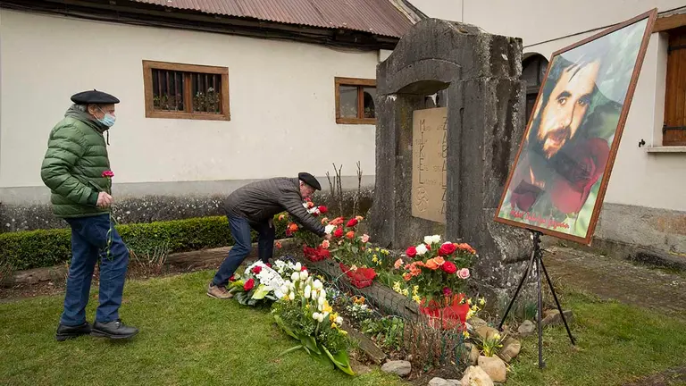 Vecinos y amigos durante la ofrenda floral en la entrega este domingo en Orbaiceta (Navarra) a la familia de Mikel Zabalza Garate de la resolución que le reconoce como víctima de abusos policiales, en un acto que se ha desarrollado en su localidad natal y al que han acudido familiares, miembros de los Gobiernos navarro y vasco y representantes de entidades memoralistas. EFE/Villar López