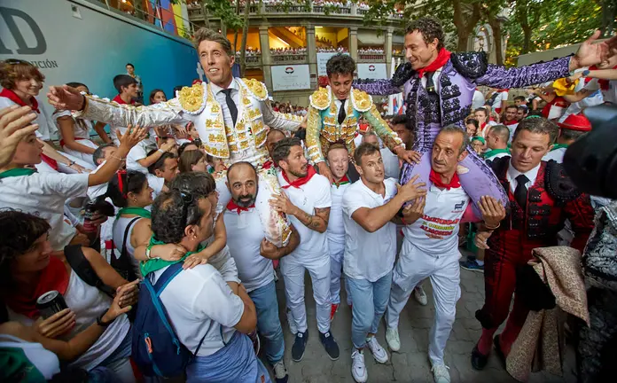 Manuel Escribano sale a hombros por la puerta grande de la Plaza de Toros de Pamplona, junto a sus compañeros de faena Rafaelillo y Leo Valadez, tras cortar dos orejas durante la cuarta corrida de la Feria del Toro de San Fermín 2022 con toros de la ganadería La Palmosilla. IÑIGO ALZUGARAY