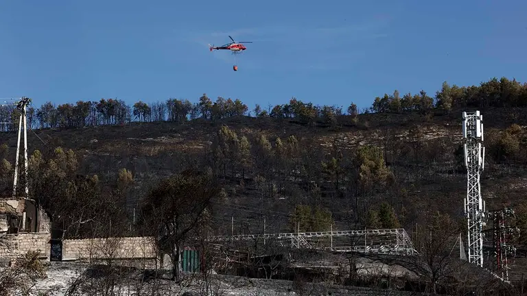 Varias dotaciones de bomberos, con unos treinta efectivos en total, siguen trabajando en el monte Ezkaba, apoyados por un helicóptero, para refrescar puntos calientes del incendio forestal declarado este martes, que anoche quedó controlado. Ayer actuaron sobre el terreno diez medios aéreos y más de 90 recursos por tierra. A las ocho y media, ya sin luz solar, se retiraron los medios aéreos y "se trabajó desde tierra de manera muy intensa, muy eficaz, y sobre las once y media de la noche se controló ya definitivamente el incendio".  EFE/ Jesus Diges
