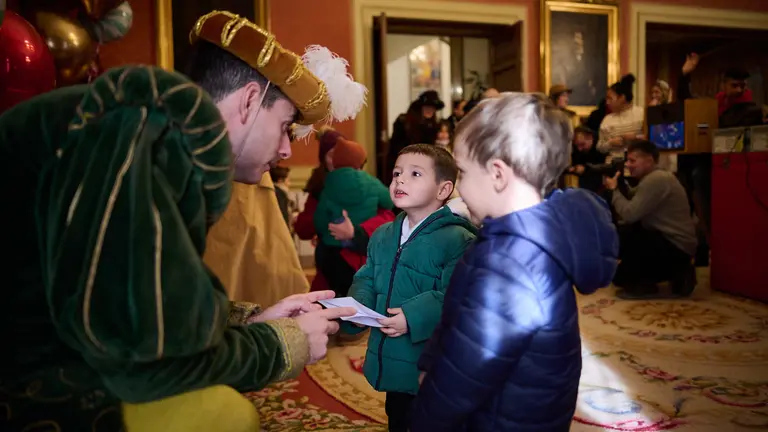 Los pajes de los Reyes Magos reciben a niños en el Salón de Recepciones del Ayuntamiento de Pamplona. PABLO LASAOSA