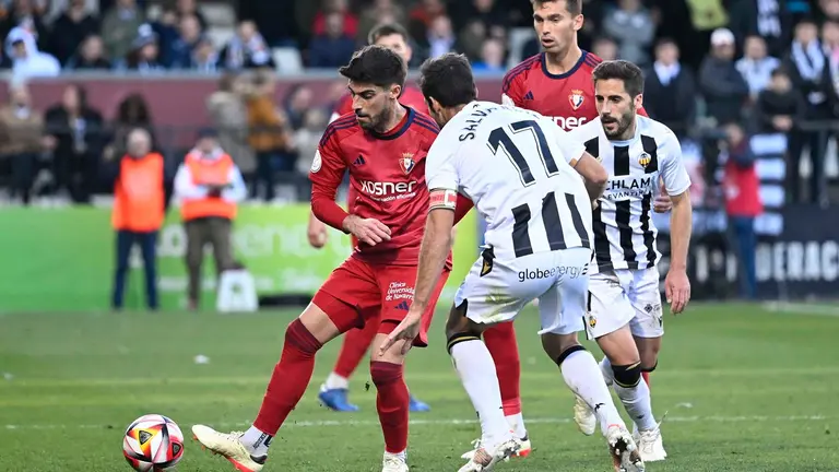 El defensa del Castellón Salva Ruiz (c) disputa un balón ante el defensa del Osasuna Nacho Vidal (i) durante el partido de dieciseisavos de final de la Copa del Rey que disputan este domingo el CD Castellón y CA Osasuna en el Estadio Municipal de Castalia. EFE/ Andreu Esteban