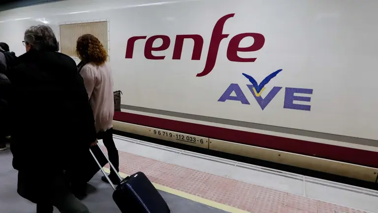 Pasajeros junto a un tren de alta velocidad ( AVE ) en una estaci&oacute;n de tren, en una imagen de archivo. EDU BOTELLA / EUROPA PRESS