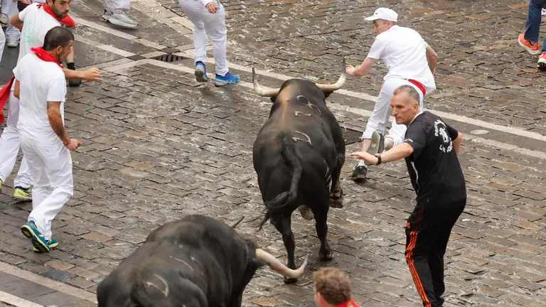 Los mozos son perseguidos por toros de la ganadería gaditana de Fuente Ymbro durante el primer encierro de los Sanfermines 2025, este lunes en Pamplona. EFE Villar Lopez
