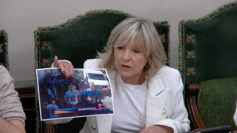 Mar&iacute;a Caballero mostrando una foto de la Korrika en la que se homenajea al asesino de su padre.