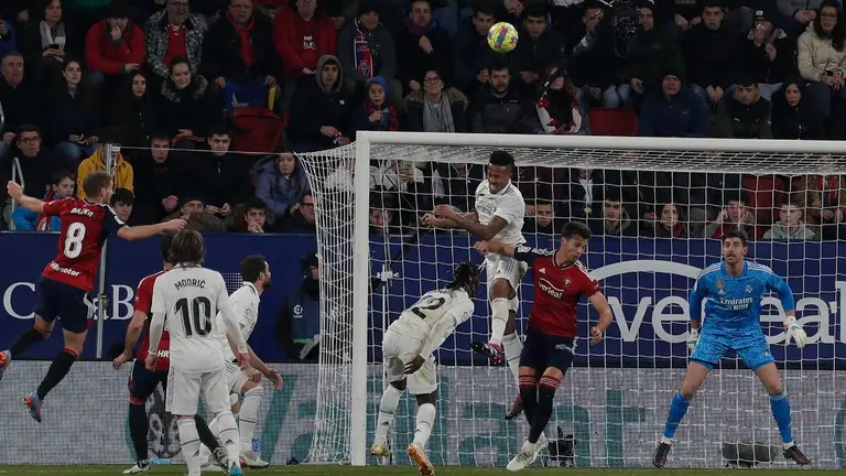 Éder Militao (3-d), defensa brasileño del Real Madrid, despeja de cabeza durante el encuentro correspondiente a la jornada 22 de primera división que disputan hoy sábado en el estadio El Sadar de Pamplona. EFE / Villar Lopez
