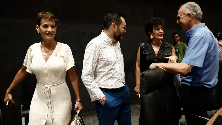 La candidata a reeditar la presidencia del Gobierno de Navarra María Chivite pasa junto al parlamentario de EH Bildu Adolfo Araiz (d) antes de comenzar su intervención para pedir la confianza de la Cámara en el debate de investidura que se celebra este lunes y martes en el Parlamento foral. EFE/ Jesus Diges