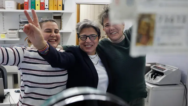 Trabajadores de la administración de loterías del número 10 de la calle Barquillo, en Madrid, donde se ha vendido íntegramente el 70.048, el segundo premio del Sorteo Extraordinario de la Lotería de Navidad. EFE/Mariscal