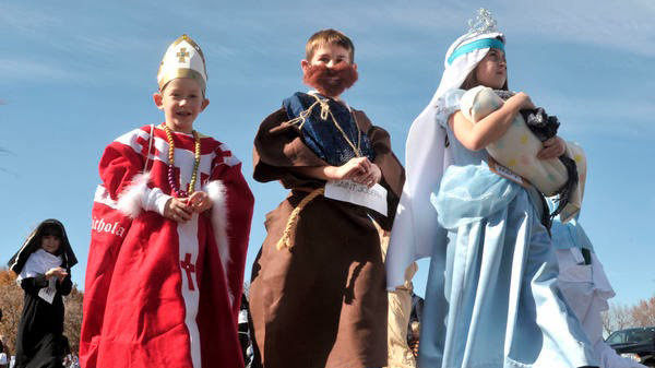 John Dixon/The News-GazetteStand Alone - From left, St. Matthew school 1st grade students Grant Evangelisti(cq), 6 (St. Nicholas), Alex Dobbins, 6 (St. Joseph) and Reagan Chladny(cq), 6 (Holy Mother Mary) parade past parents, family and other students in the school&#39;s annual All Saints Day parade in Champaign on Friday Oct. 26, 2012.