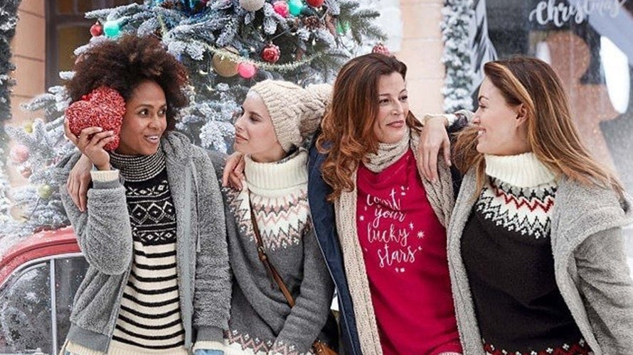 Varias mujeres visten con jerseys navideños