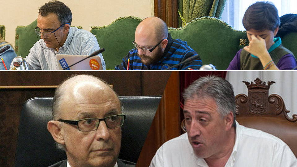 Los concejales de Aranzadi junto a las imágenes del ministro de Hacienda, Montoro, junto al alcalde de Pamplona, Asirón
