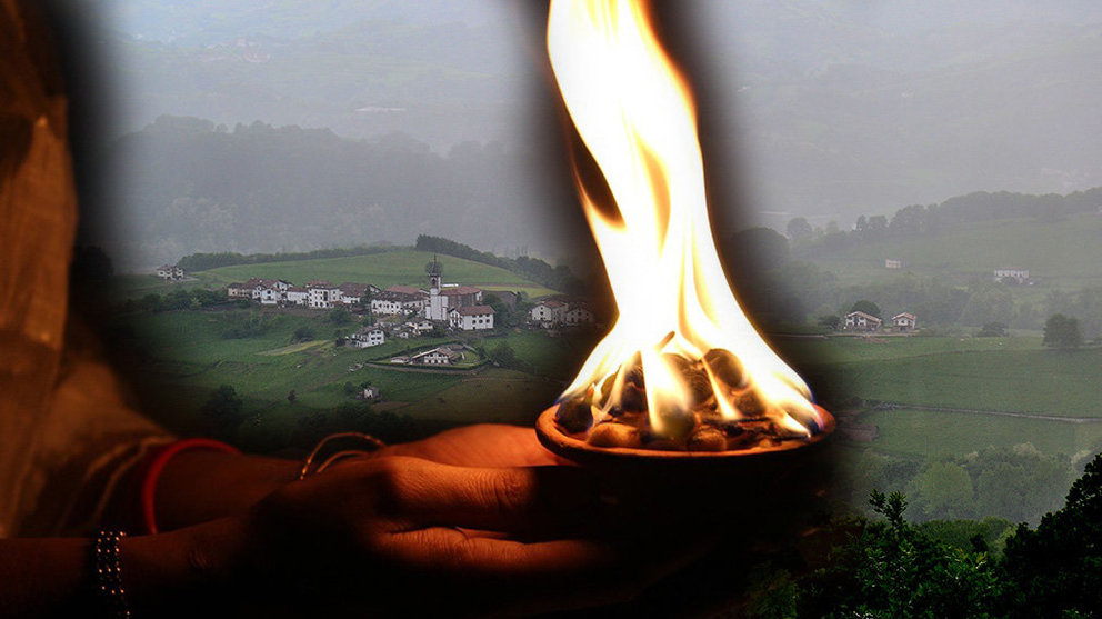 Imagen de un chamán quemando varias hierbas y frutos para preparar un brebaje junto con una localidad del valle de Baztán de fondo FOTOMONTAJE NAVARRACOM