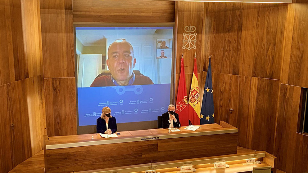 La consejera Ollo y el director general, Martín Zabalza, con el director del informe, Javier Dorado en pantalla, durante la comparecencia de prensa. GOBIERNO DE NAVARRA