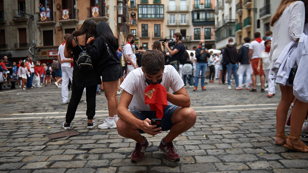 Un joven se arrodilla y besa el pañuelo de San Fermín durante las no fiestas de 2021. MIGUEL OSÉS