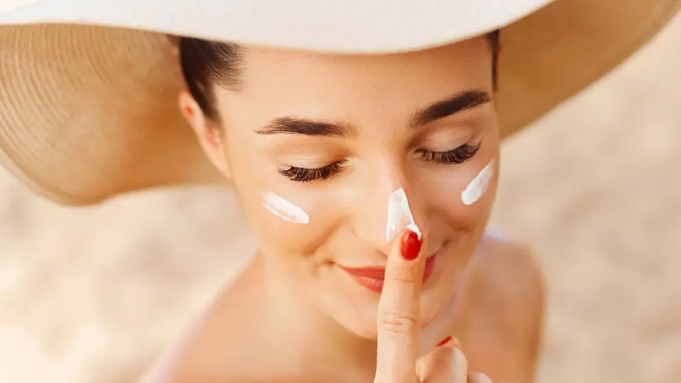 Mujer usa crema protectora. - QUIRÓNSALUD - Archivo