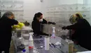 Varias personas trabajan en la limpieza de las urnas para las elecciones en Pamplona.