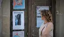 Una mujer pasa junto a un cartel con sobre Diana Quer en A Pobra. G. Araluce