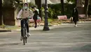 Una persona anda en bicicleta por Pamplona con mascarilla para evitar propagar el coronavirus. PABLO LASAOSA
