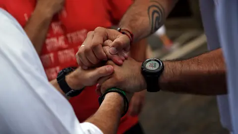 Sergio Colas (R) greets another runner after coming out unscathed from the first bull run of the San Fermin festival in Pamplona, northern Spain, July 7, 2016.