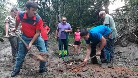 La Patrulla de Medio Ambiente de la Policía Foral y varios ganaderos retiran con palas la tierra para liberar a una vaca que se ha hundido en la Sierra de Urbasa PF