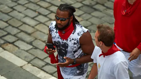 El jugador de fútbol americano Josh Norman, en el quinto encierro de los Sanfermines con toros de Victoriano del Río. MIGUEL OSÉS