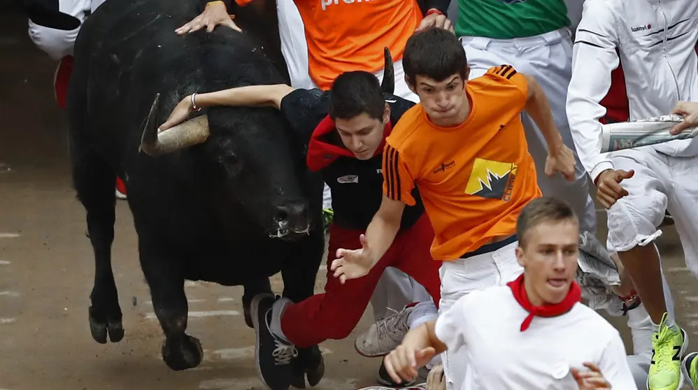 GRA002. PAMPLONA, 11/07/2017.- Varios mozos corren ante un toro de la ganader&iacute;a de Jandilla a la entrada de la Plaza de Toros de Pamplona, en el quinto encierro de los Sanfermines 2017 que ha sido el m&aacute;s r&aacute;pido hasta ahora con una duraci&oacute;n de dos minutos y doce segundos, y que ha finalizado, en principio, sin heridos por asta de toro. EFE/Jes&uacute;s Diges